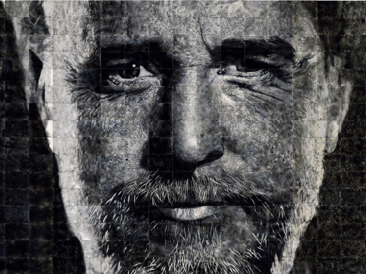 Black and white mosaic of a man's face with a beard