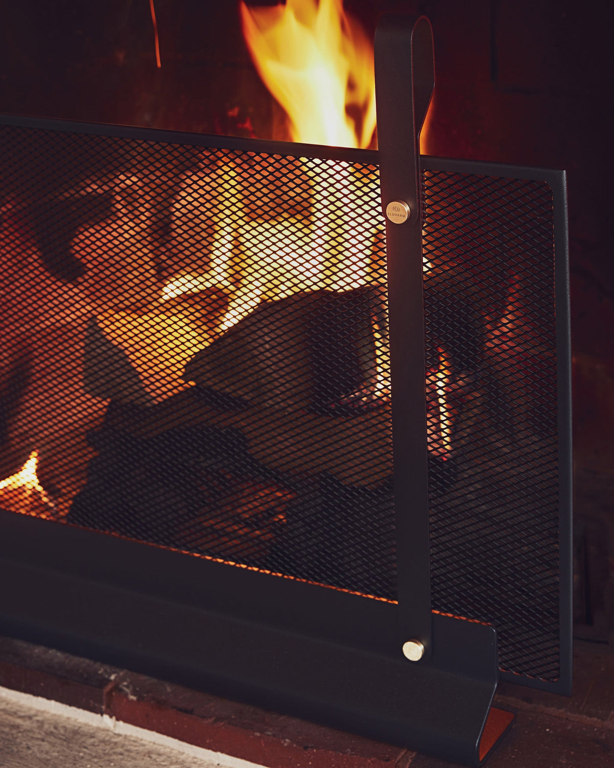 Eldvarm Emma Fireplace Screen - Noir B in a styled interior setting