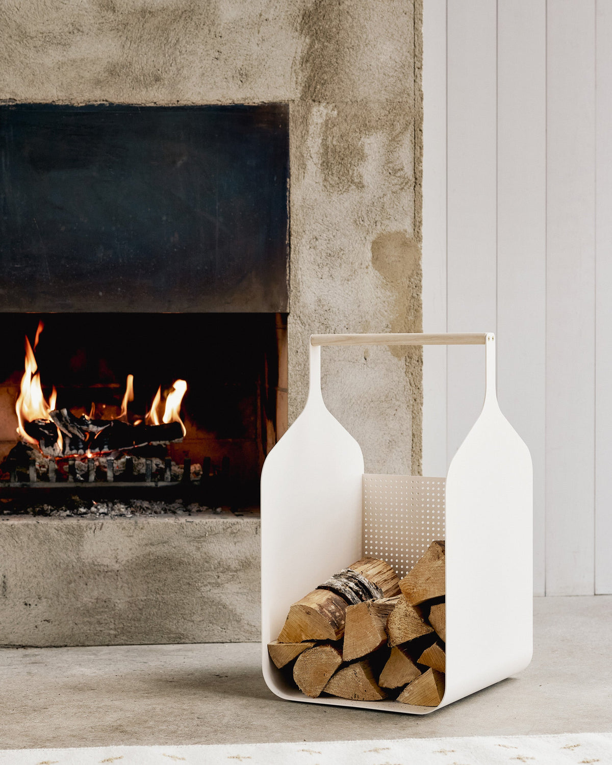 Eldvarm Fumi Log Holder - Blanc in a styled interior setting