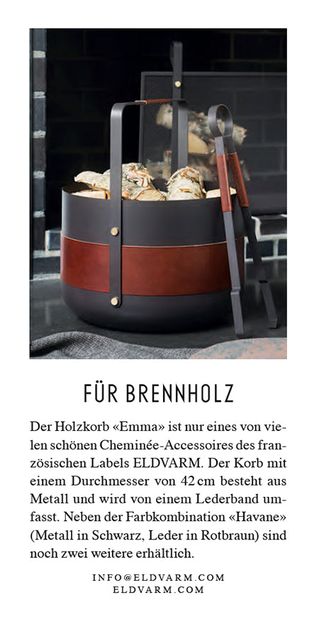 Brennholzkorb with leather band and metal base on a dark background