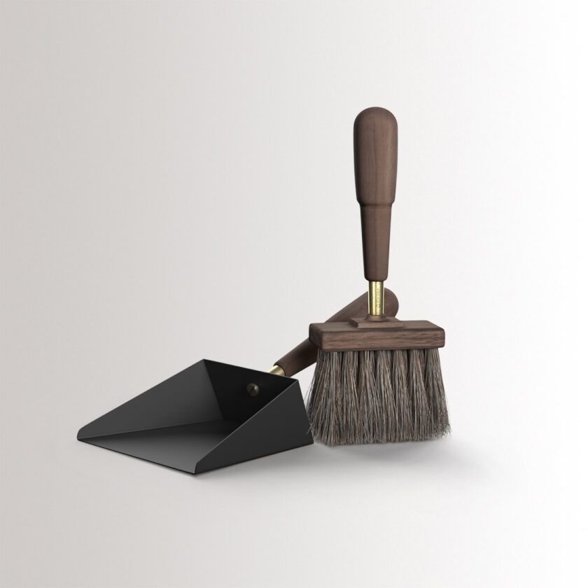 Emma Shovel & Brush in Graphite combines charcoal black powder-coated steel, with walnut wood and brass details, at an angle.