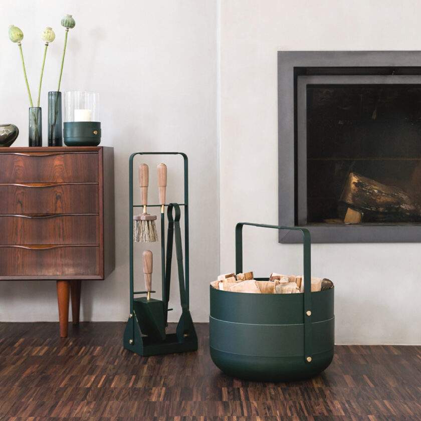 Emma Basket in Forêt (green powder-coated steel, green leather and solid brass details) with the fireplace tools in the same colour.