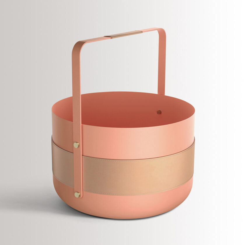 Emma Basket in BonBon is made of peachy pink powder-coated steel, beige leather, beech wood, and brass details.