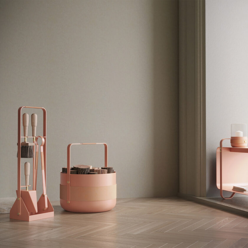 Emma Basket in BonBon (peachy pink powder-coated steel, beige leather, beech wood, and brass details) with other products in the same colour.