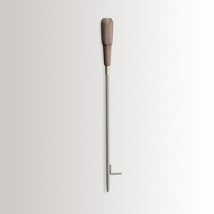 Emma Blow Poker in Paris combines medium grey powder-coated steel, with a walnut wood handle and brass details.
