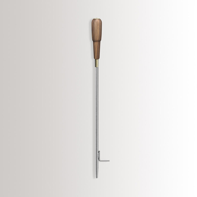 Emma Blow Poker in Lumière combines stainless steel, with an oiled walnut wood handle and brass details.