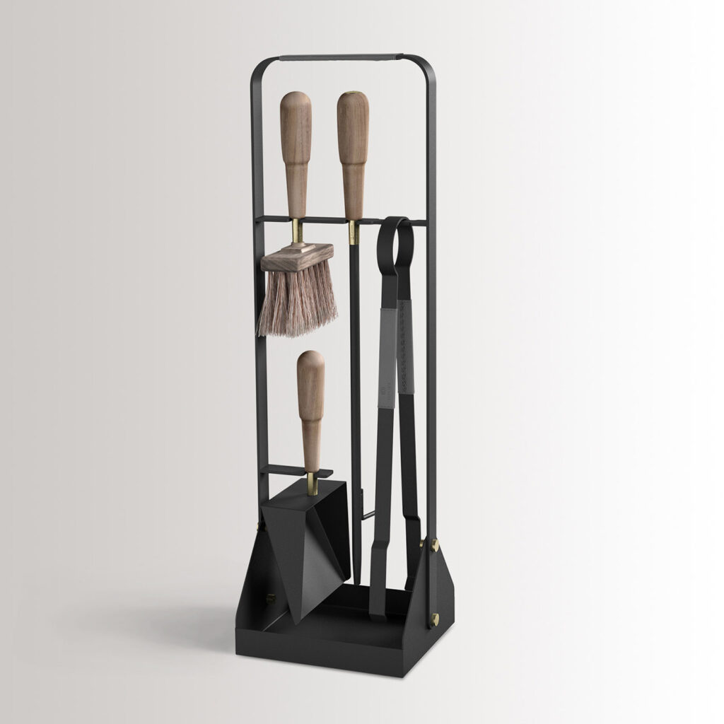 Emma Companion Set in Graphite combines charcoal black powder-coated steel, with “Ellie” grey leather, walnut wood handles and details in solid brass.