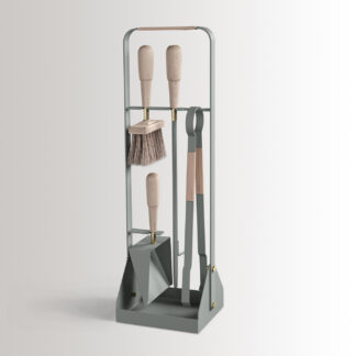 Emma Companion Set in Lichen combines light green grey powder-coated steel, with “Naturel” beige leather, beech wood handles and details in solid brass.