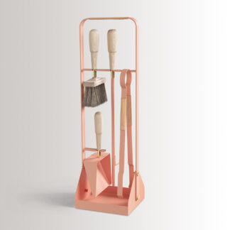 Emma Companion Set in BonBon is made of peachy pink powder-coated steel, with “Naturel” beige leather, beech wood handles and details in solid brass.