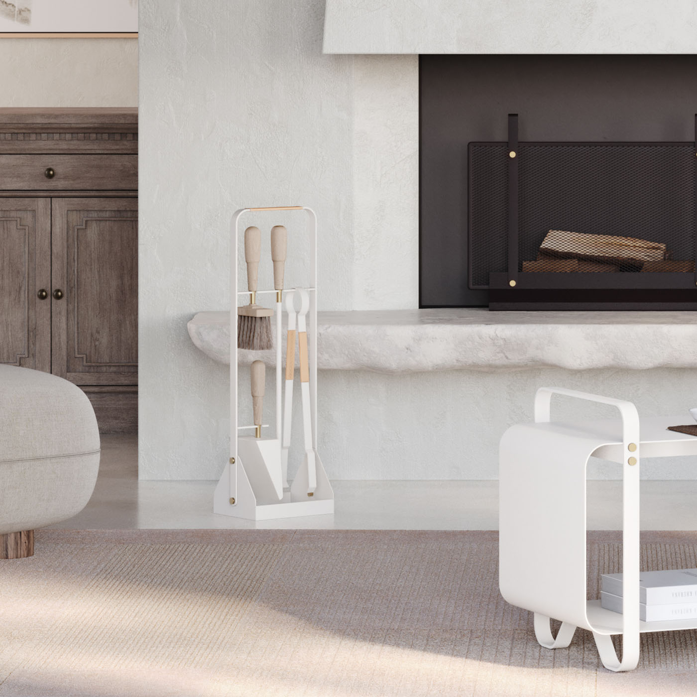 Emma Companion Set in Blanc (cream white powder-coated steel, “Naturel” beige leather, beech wood handles and solid brass details) in a living room with a fireplace.