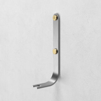 Emma Wall Hook in Lumière is made of stainless steel, with brass details.