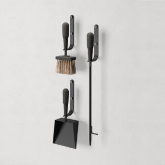 Emma Wall in Noir (charcoal black powder-coated steel, black stained beech wood and black details) includes 3 wall hooks, a blow poker, and a shovel and brush.