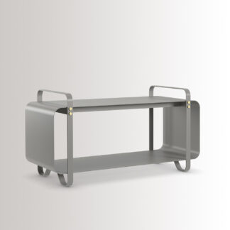 Ninne Bench in Paris is made from medium grey powder-coated steel, with brass details, at an angle.