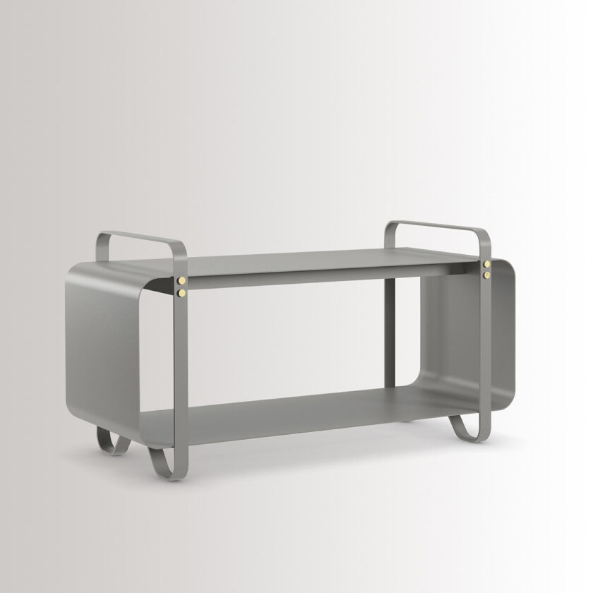 Ninne Bench in Paris is made from medium grey powder-coated steel, with brass details, at an angle.