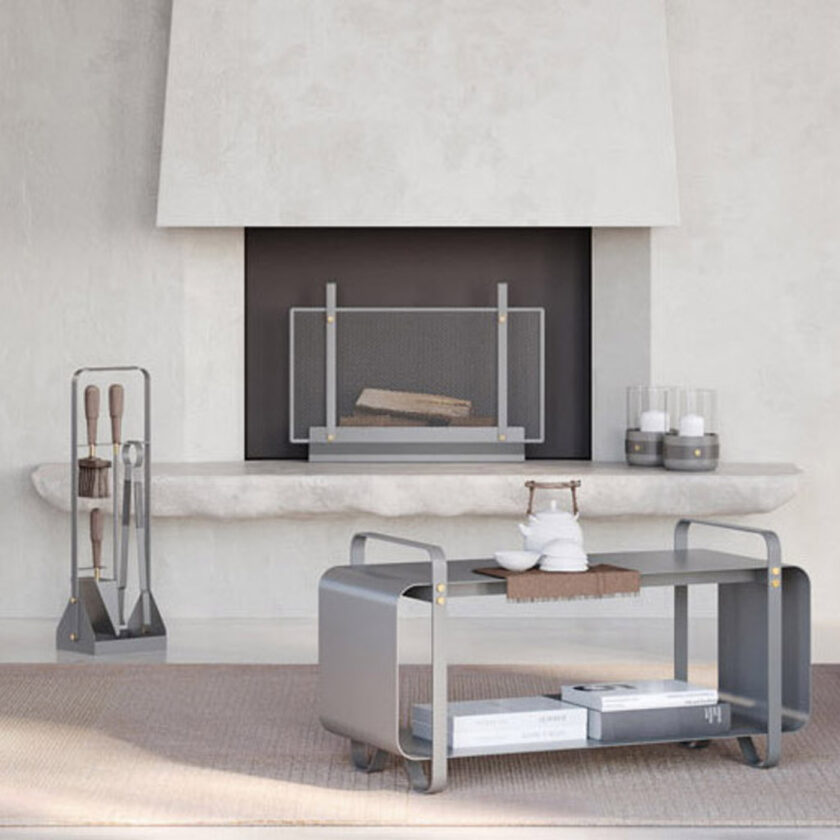 Ninne Bench medium grey as a coffee table, Emma Firescreen in Paris in front of an unlit fire, a pair of Emma Lanterns in Paris next to the firescreen and on the left the Emma Companion Set in Paris.