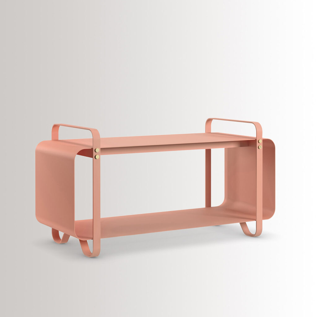 The outdoor version of the Ninne Bench in BonBon combines pink powder-coated galvanised steel, with brass details, at an angle.