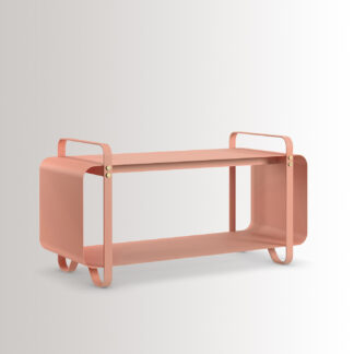 Ninne Bench in BonBon is made from pink powder-coated steel, with brass details, at an angle.