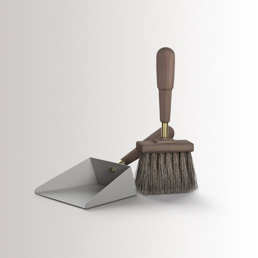 Emma Shovel & Brush in Paris combines medium grey powder-coated steel, with walnut wood and brass details, at an angle.
