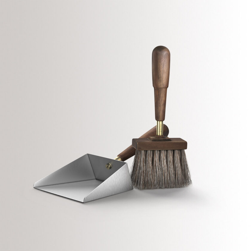 Emma Shovel & Brush in Lumière combines stainless steel, with oiled walnut wood and brass details, at an angle.