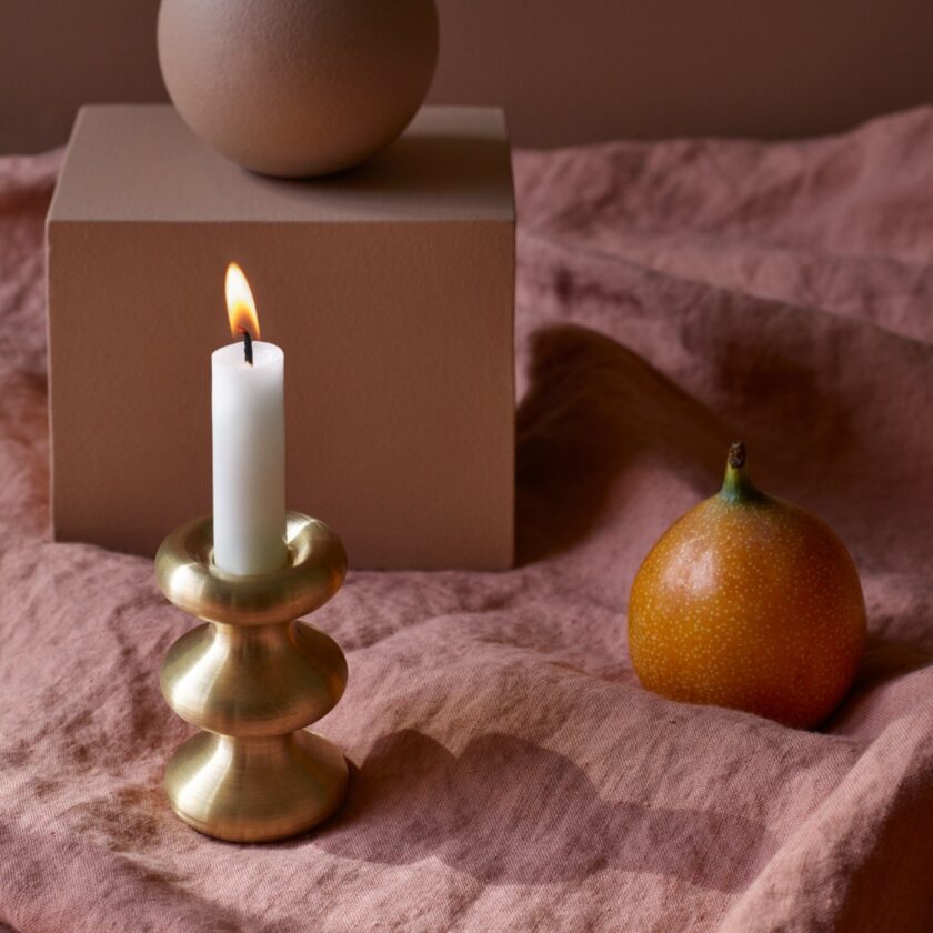 LouLou candleholder in solid brass, with lit candle