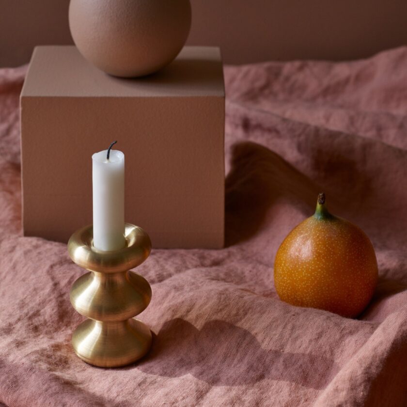 LouLou candleholder in solid brass, shown here with unlit candle