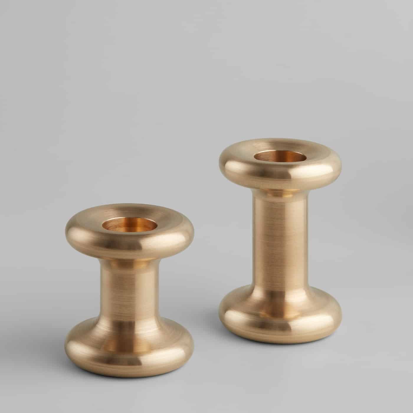 A pair of solid brass Lucie Candle Holders, without candles, on a plain background.