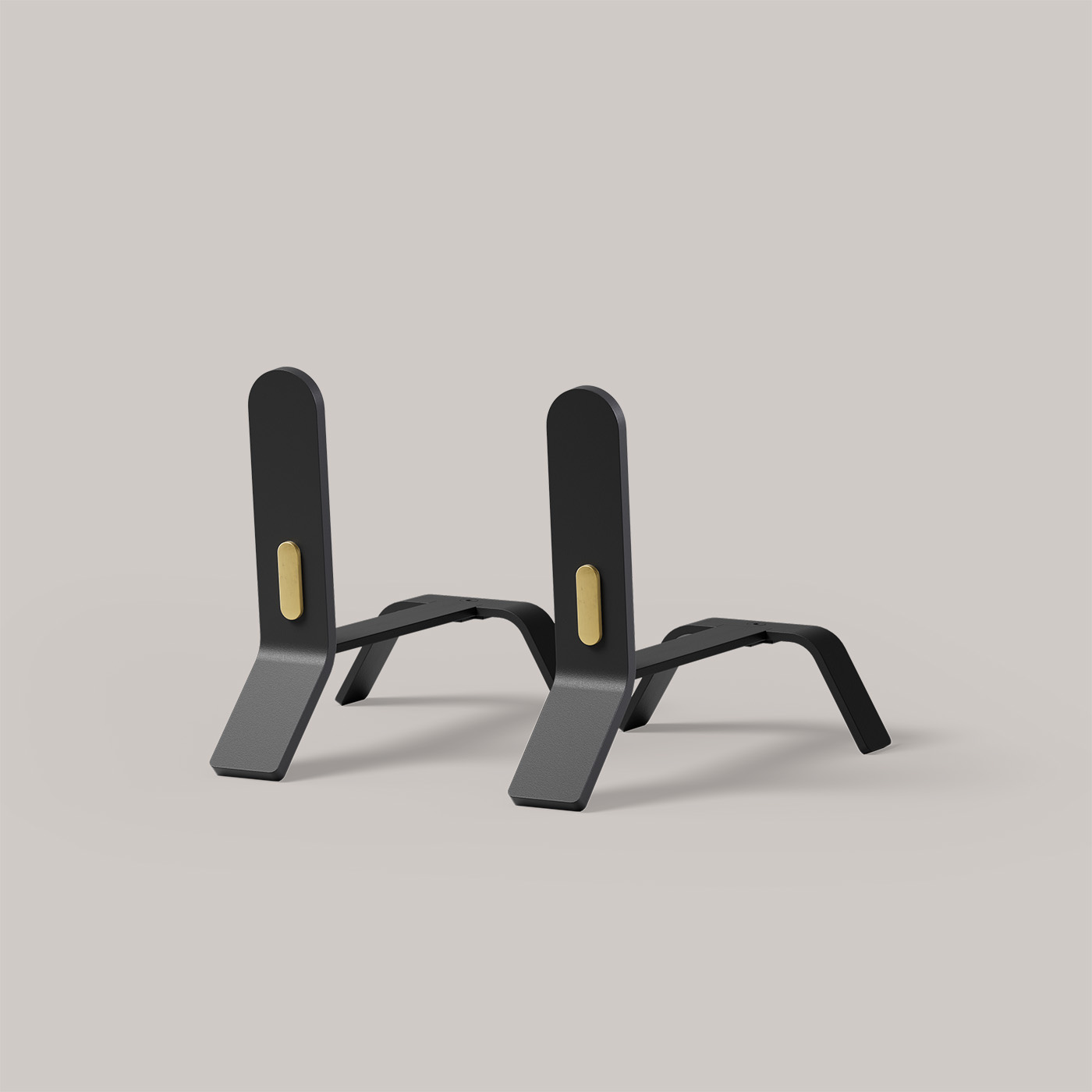 A pair of sleek, black metal stands with gold-colored accents at the center of the vertical supports. The stands have a modern, minimalist design with angular bases and a smooth matte finish, set against a plain light grey background.