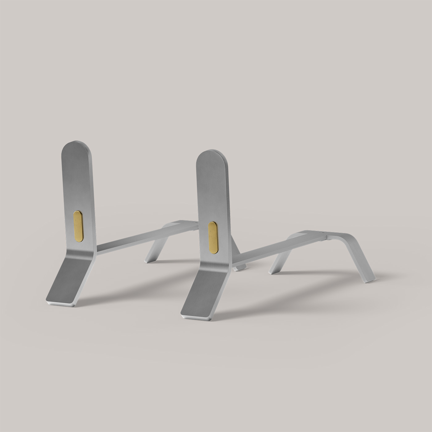A pair of sleek, modern, silver-colored push-up bars on a white background. Each bar has a rectangular gold accent on the vertical support. Designed with a minimalist aesthetic for exercise and fitness routines.