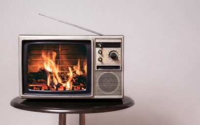 Images showing a television with a video of a fireplace
