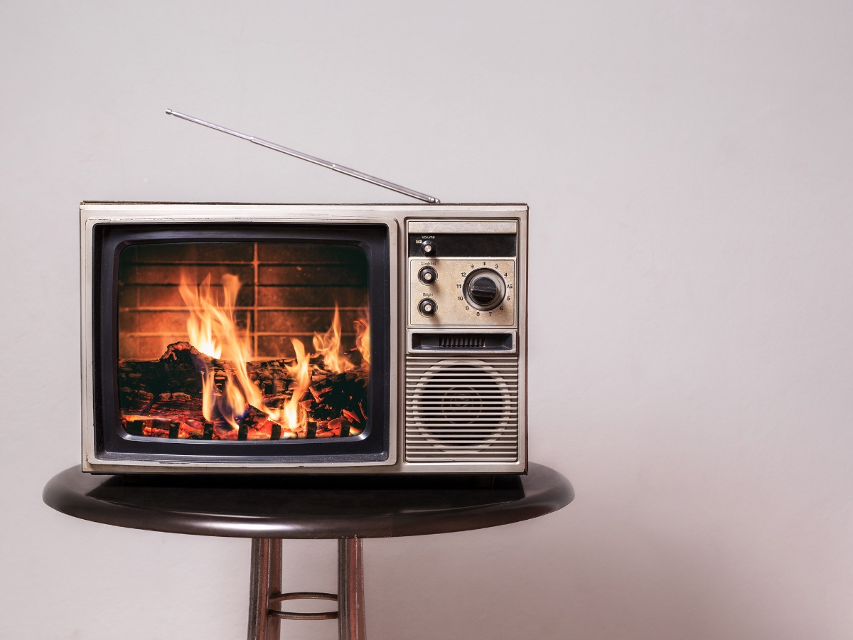 Images showing a television with a video of a fireplace
