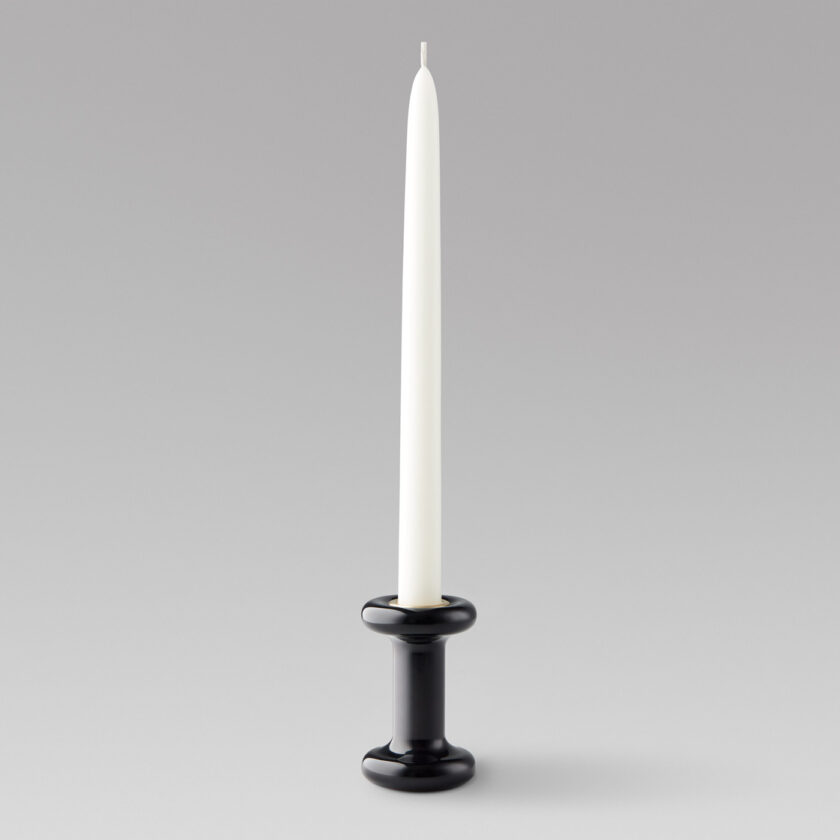 Lucie Candle Holder Tall in Noir (black powder-coasted steel) with a brass insert and unlit candle.
