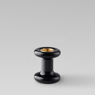 Lucie candle holder short in Noir (black powder-coated steel) with a brass insert without a candle.