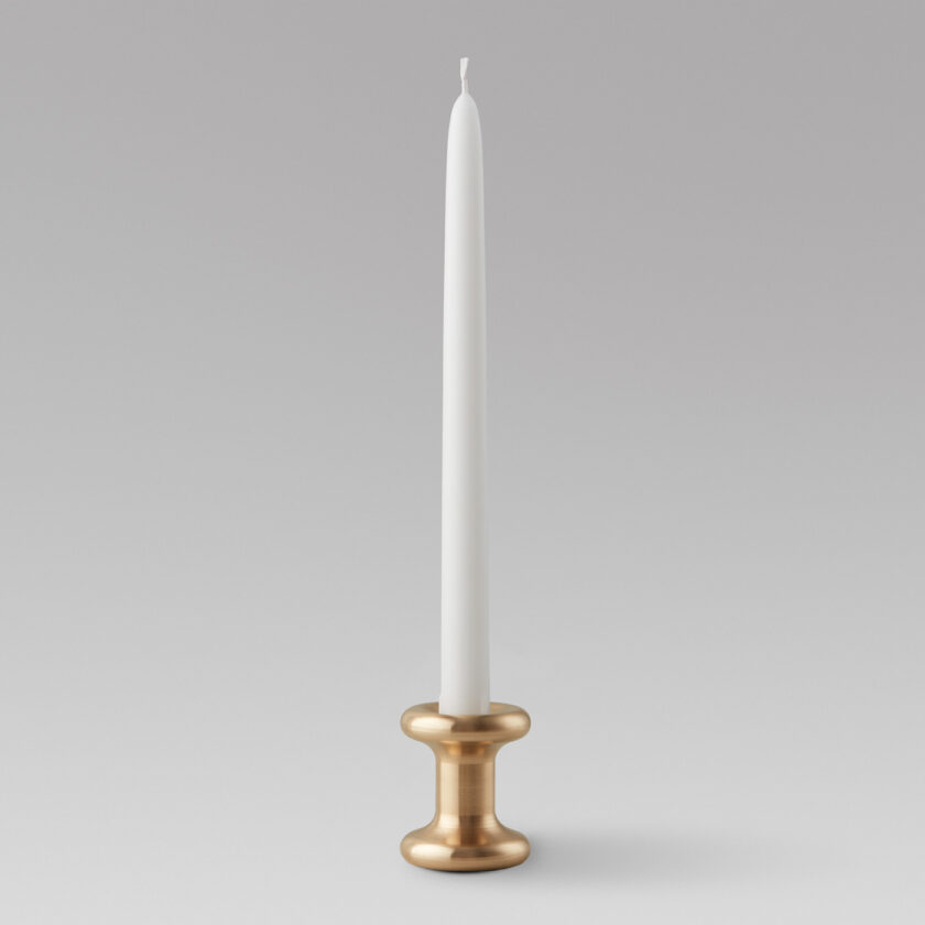 Lucie Candle Holder short in solid Brass with an unlit candle.