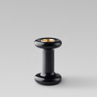 Lucie Candle Holder Tall in Noir (black powder-coasted steel) with a brass insert without a candle.