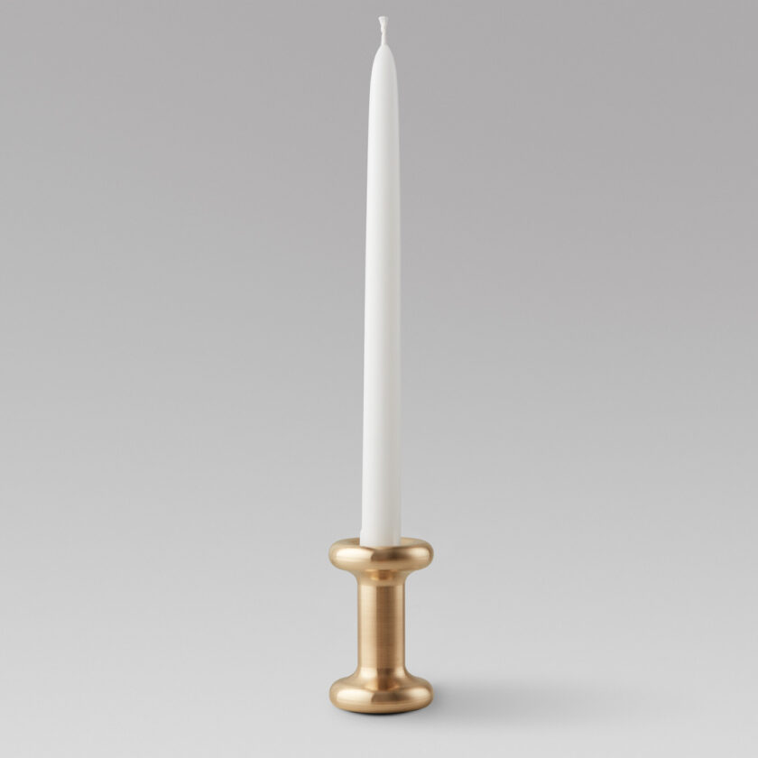 Lucie Candle Holder Tall in solid Brass with an unlit candle.
