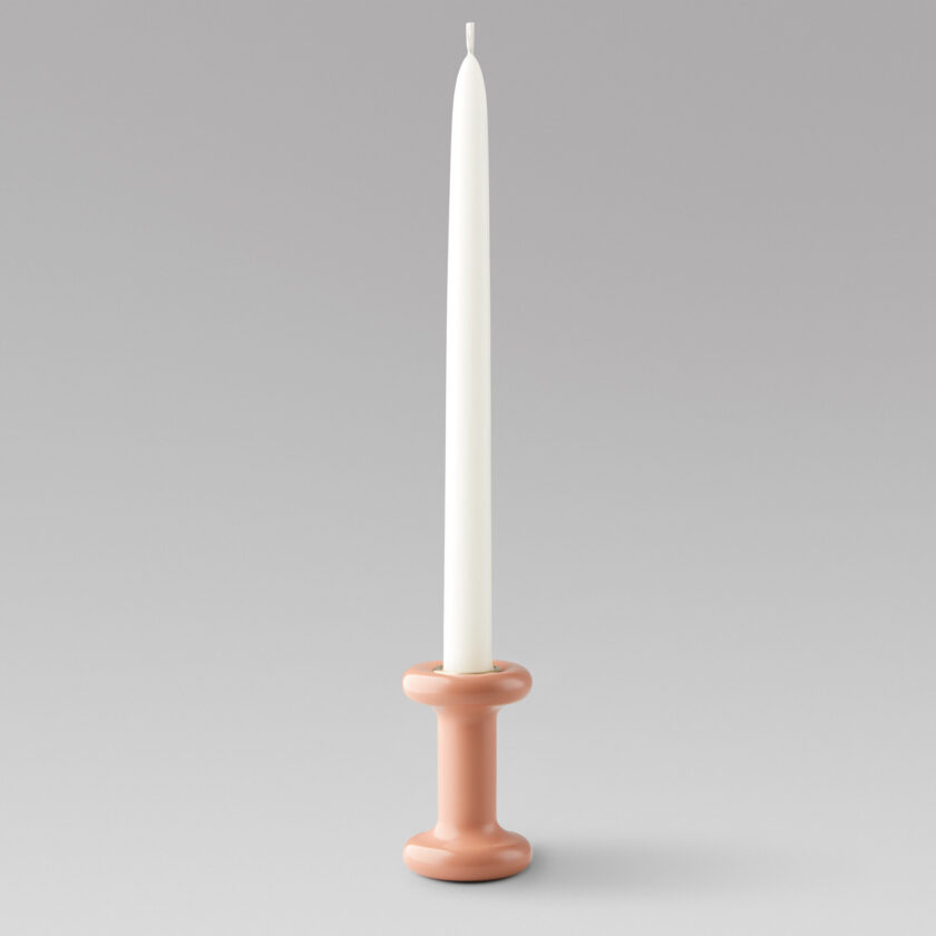 Lucie Candle Holder Tall in BonBon (pink powder-coasted steel) with a brass insert and unlit candle.