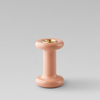 Lucie candle holder tall in Bonbon (pink powder-coated steel) with a brass insert without a candle.