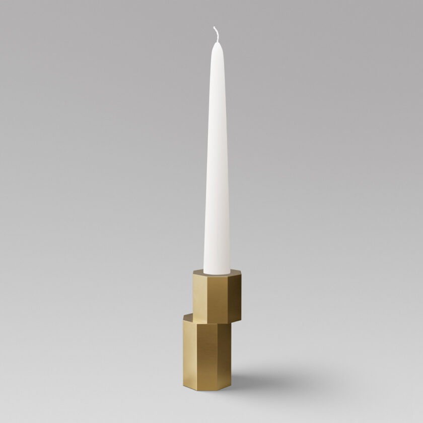 Luca Candle Holder in Brass with an unlit candle.