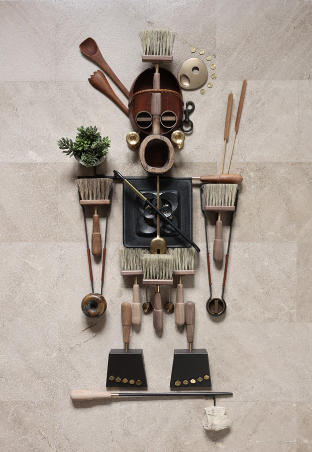 Paternal Pride - An imaginative collage of items coming together to create a figure, created by Philip Howlett of Herringbone Design. It features several Eldvarm products, including two Tall Brass Lucie Candle Holders, a Graphite Shovel and Brush, a Naturel Blow Poker, and two Havane Tongs.