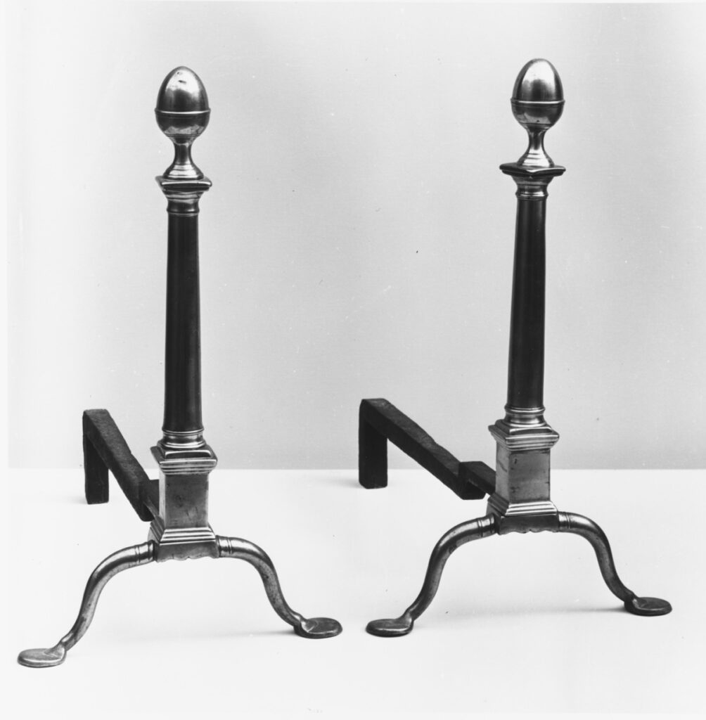 A pair of antique brass andirons dating to between 1770-1800. They are on display in gallery 774 at The Metropolitan Museum of Art in New York City.