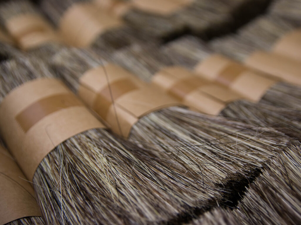 A close up shot of bundles of horsehair and tampico (the root of the agave cactus) A special blend of these two materials is used for making the Emma Brush.