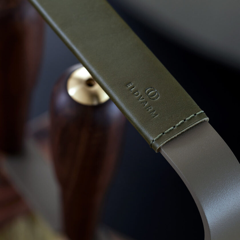 A close up of the olive green hand stitched leather on the handle of the Emma Companion Set.