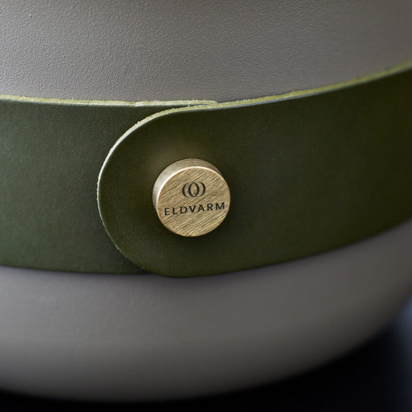 A close up of the olive green leather strap and brushed brass screw on the Emma Lantern Olive.