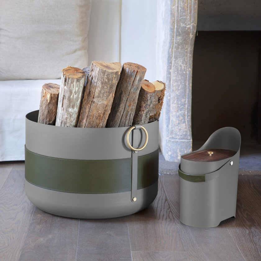 Emma Basket XL in Olive with logs for a fire, alongside the Tilda Ash Bucket