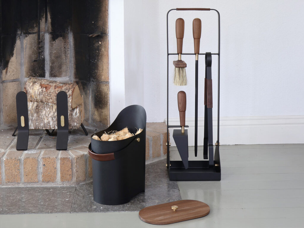 Tilda Bucket with kindling, next to Emma Companion Set and Cooper Fire Dogs, in fireplace setting